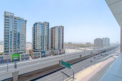 a highway in a city with tall buildings at Lovely Studio & Budget Friendly in Dubai
