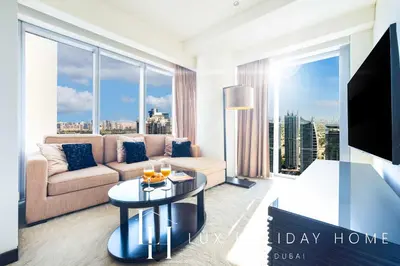 a living room with a couch and a table at LUX The JW Marina Suite in Dubai