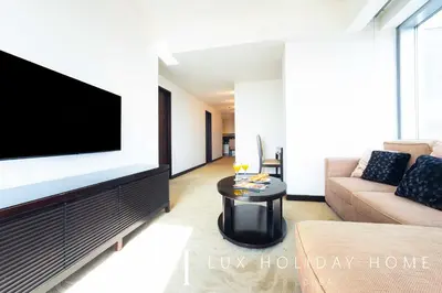 a living room with a tv and a couch at LUX The JW Marina Suite in Dubai