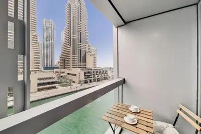 a room with a balcony with a view of the city at Cayan Tower, Dubai Marina - Charming One Bedroom in Dubai