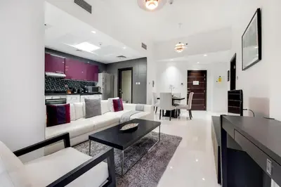 a living room with a white couch and a table at Cayan Tower, Dubai Marina - Charming One Bedroom in Dubai