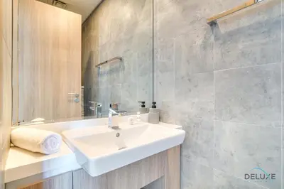 a bathroom with a sink and a mirror at Cosmopolitan 2BR at Stella Maris Dubai Marina by Deluxe Holiday Homes in Dubai