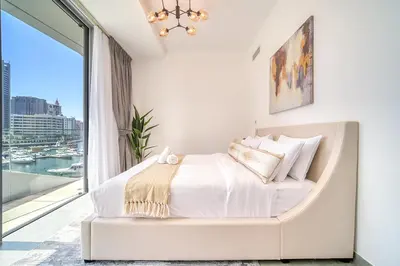 a bedroom with a bed with a large window at Spacious 1 Bed Apt - Stella Maris at Dubai Marina By PK Holidays in Dubai