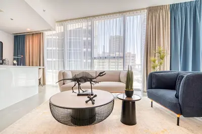 a living room with a couch and a table at Spacious 1 Bed Apt - Stella Maris at Dubai Marina By PK Holidays in Dubai