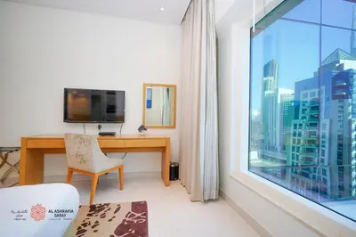 a room with a desk and a large window at Modern Spacious 2BR Canal View -Business Bay in Dubai