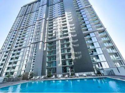 a large building with a swimming pool in front of it at STAY BY LATINEM Luxury 1BR Holiday Home CV B905 near Burj Khalifa in Dubai