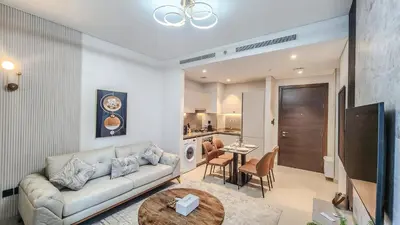 a living room with a couch and a table at STAY BY LATINEM Luxury 1BR Holiday Home CV B905 near Burj Khalifa in Dubai
