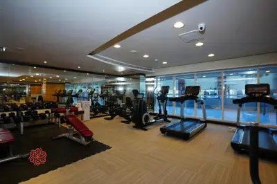 a gym with treadmills and cardio equipment in a building at Al Ashrafia Saray Marvelous 1 BR - Damac Maison - Canal View in Dubai