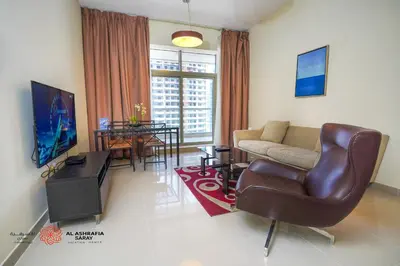 a living room with a couch and a table at Unique 1BR Apartment in Sport City in Dubai