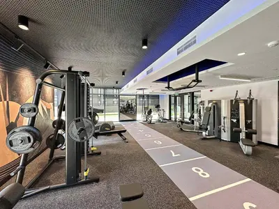 a gym with cardio equipment in a building at Silkhaus modern studio in the heart of vibrant JVC in Dubai