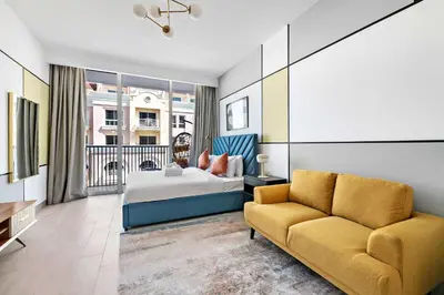 a hotel room with a bed and a couch at Silkhaus new stylish studio in JVC Luma21 in Dubai