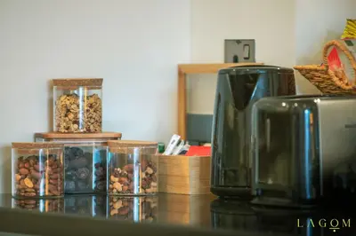 a counter with two jars of nuts and a coffee maker at Songs of the Lake by Lagom - Bonnington Apartment Jumeirah Lake Towers, in Dubai
