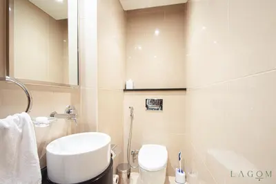 a bathroom with a white sink and a toilet at Songs of the Lake by Lagom - Bonnington Apartment Jumeirah Lake Towers, in Dubai