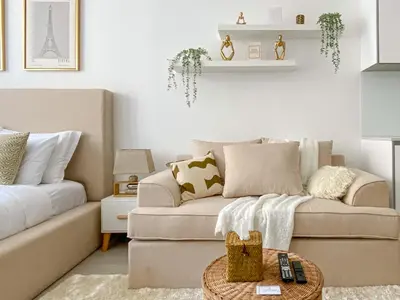 a living room with a couch and a table at Trophy - Urban Escape Suite in Dubai