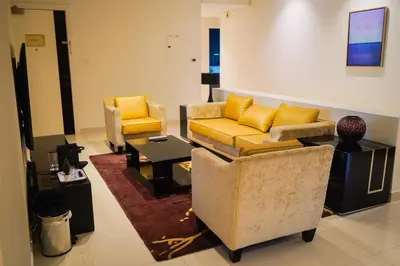 a living room with two chairs and a couch at Al Ashrafia Saray Magnificent 3BR Canal Views in Dubai