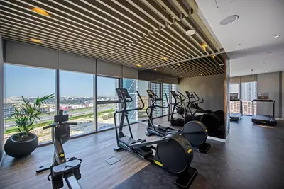 a gym with treadmills and ellipticals in a building at La Dolce Vita Residence by Suiteable Interiors in Dubai