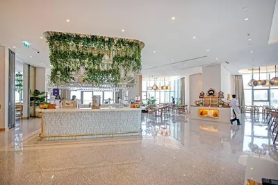 a lobby with a bar in the middle of a building at La Dolce Vita Residence by Suiteable Interiors in Dubai