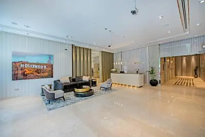 a lobby of a hotel with a couch and chairs at La Dolce Vita Residence by Suiteable Interiors in Dubai