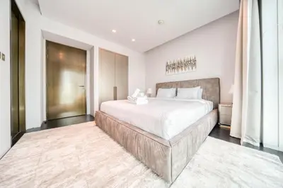 a bedroom with a large bed and a large window at Damac Heights, Dubai Marina - Mint Stay in Dubai