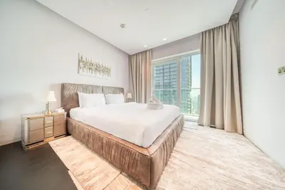 a bedroom with a large bed and a large window at Damac Heights, Dubai Marina - Mint Stay in Dubai