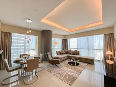 a living room with a couch and a table at Luton Vacation Homes - Damac Paramount 2BR High Floor, Business Bay, Dubai 61AB06 in Dubai