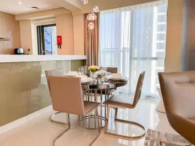 a dining room with a table and chairs at Luton Vacation Homes - Damac Paramount 2BR High Floor, Business Bay, Dubai 61AB06 in Dubai