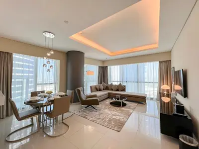a living room with a couch and a table at Luton Vacation Homes - Damac Paramount 2BR High Floor, Business Bay, Dubai 61AB06 in Dubai