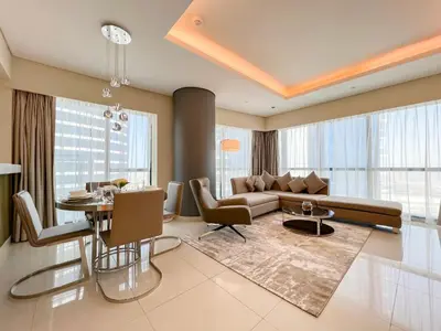 a living room with a couch and a table at Luton Vacation Homes - Damac Paramount 2BR High Floor, Business Bay, Dubai 61AB06 in Dubai