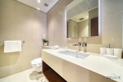 a bathroom with a sink and a toilet and a mirror at Surreal 1BR at The Residence Marina Gate 2 Dubai Marina by Deluxe Holiday Homes in Dubai