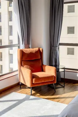 a orange chair sitting in a room with a window at Luxury 1 bedroom with amazing full sea view! in Dubai