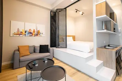 a living room with a couch and a table at Exclusive Designer Studio by Marina, Beach & Mall in Dubai