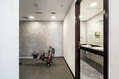 a bathroom with a treadmill and a mirror at Exclusive Designer Studio by Marina, Beach & Mall in Dubai