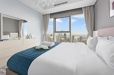 a bedroom with a large bed with a large window at StoneTree - Paramount Tower Hotel & Residences 2 BR - Infinity Pool & Stunning View in Dubai