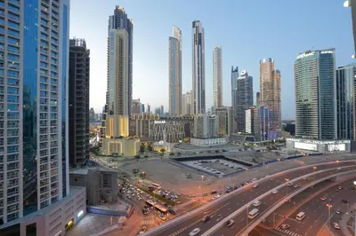 a city skyline with tall buildings and a highway at Lux Studio in Downtown, 5 mins to Burj Khalifa & Dubai Mall - MAG318 in Dubai