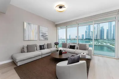 a living room with a couch and a table at Maison Privee - Deluxe 3BR Apt with Dubai Marina Vws & Beach Access in Dubai