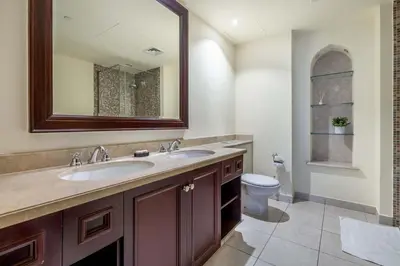 a bathroom with two sinks and a toilet at GuestReady - Sweet Sunshine in Downtown in Dubai