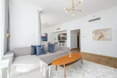a living room with a couch and a table at LUX The JBR Beach Sea View Suite in Dubai