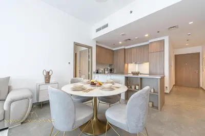 a kitchen and dining room with a table and chairs at Marco Polo - Wake up to stunning sea views at Stella Maris in Dubai