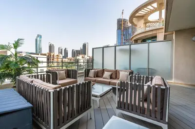 a balcony with chairs and couches on a building at Stylish and Central 1 BD in Downtown Dubai in Dubai