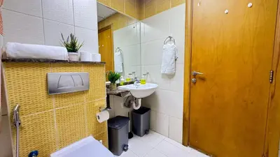 a bathroom with a sink and a mirror at Spacious studio apartment in Dubai Marina close to metro and beach in Dubai