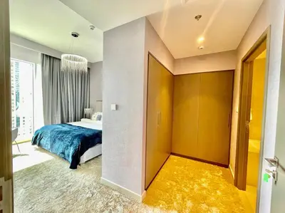 a bedroom with a bed and a large window at Elegant & Chic 2bedroom balcony Creek Waterfront in Dubai