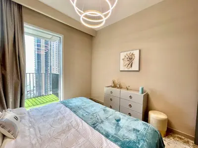 a bedroom with a bed and a large window at Elegant & Chic 2bedroom balcony Creek Waterfront in Dubai