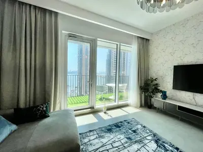 a large living room with a large window and a television at Elegant & Chic 2bedroom balcony Creek Waterfront in Dubai