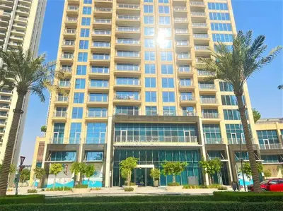 a large building with palm trees in front of it at Modern & Chic Waterfront 2bed balcony Dubai Creek in Dubai