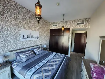 a bedroom with a large bed in a room at Upgraded 1 Bhk Silicon Oasis Short or long rental in Dubai