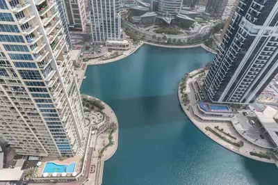 an aerial view of a river between tall buildings at Scenic lake view 2BR near metro in Cluster A, JLT - Allsopp&Allsopp in Dubai