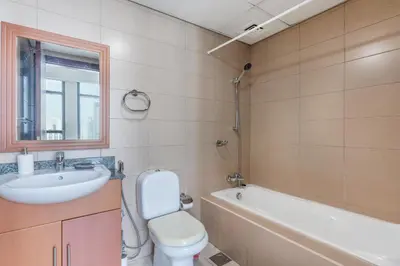 a bathroom with a sink and a toilet and a tub at Scenic lake view 2BR near metro in Cluster A, JLT - Allsopp&Allsopp in Dubai