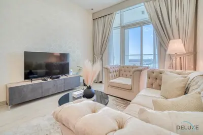 a living room with couches and a tv at Peaceful 1BR in Studio One Dubai Marina by Deluxe Holiday Homes in Dubai