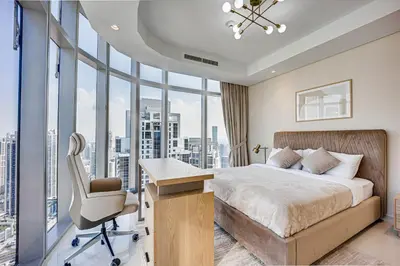 a bedroom with a bed and a desk and a chair at Luxury 3 bedroom apartment in Paramount Midtown in Dubai