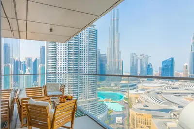 a balcony with chairs and a view of a city at EDEN'S Homes & Villas - Boulevard Point in Dubai